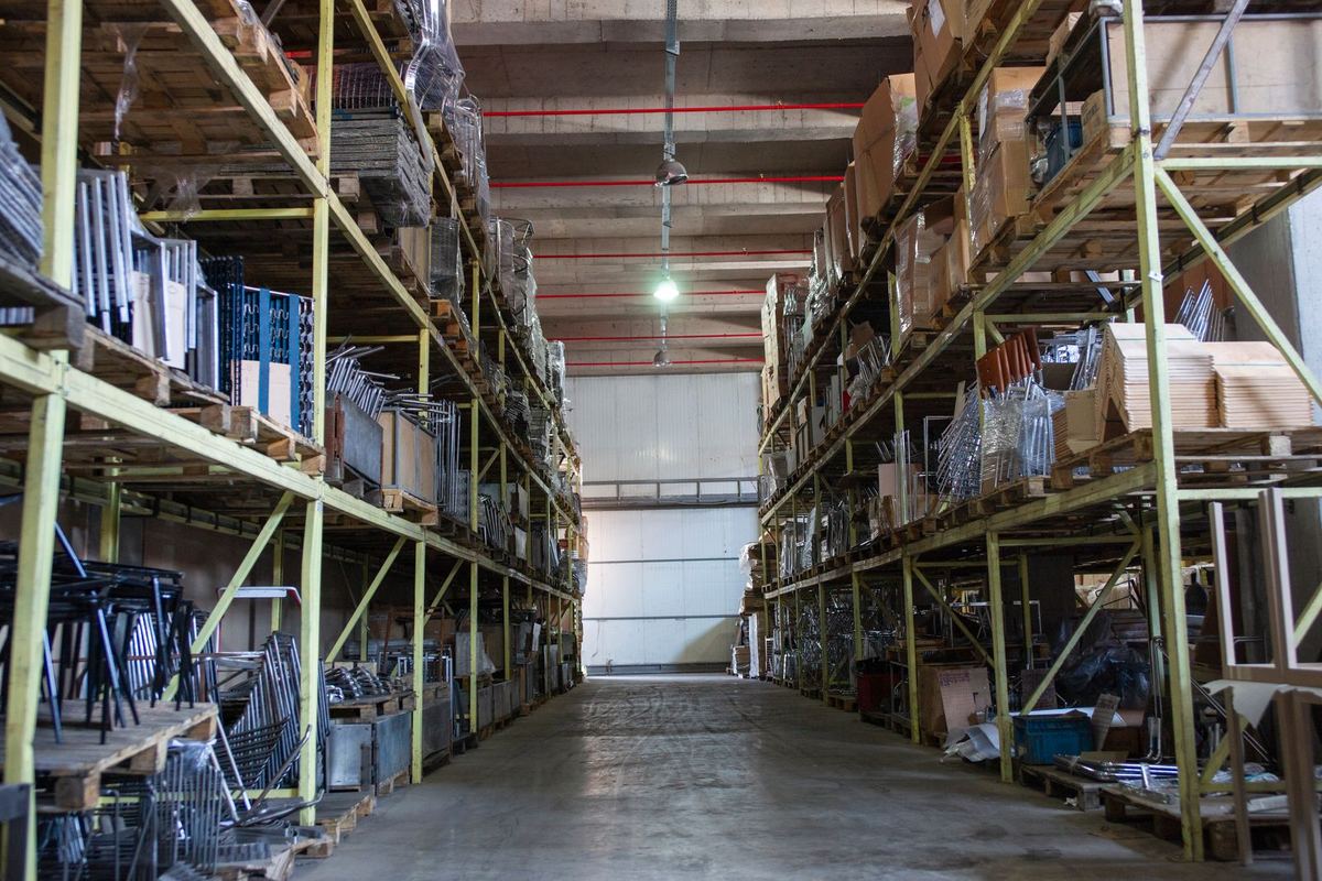 Wide warehouse aisle, industrial shelving